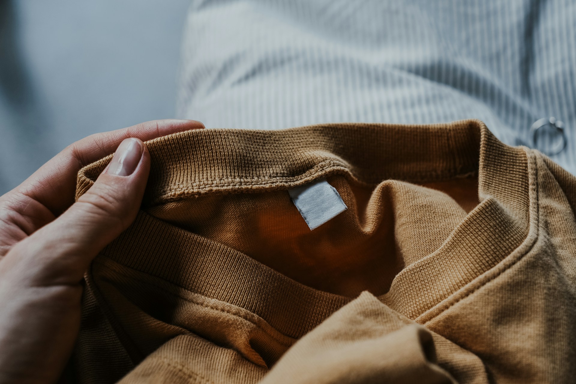 A person holding a brown shirt