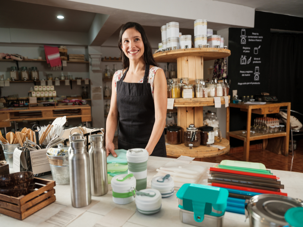 Eco-Friendly Branding with promotional items – A woman selling bamboo notebooks, wooden mugs, eco tote bags etc. 